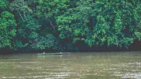 Traditional Dayak fisherman catching fish in upper Mahakam riverの写真素材