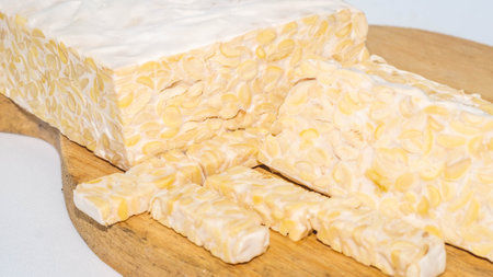 Raw slices of Tempeh, typical Indonesian food fermented made from fermented soybeans. Tempeh is very...