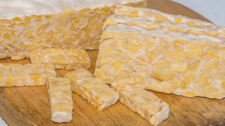 Raw slices of Tempeh, typical Indonesian food fermented made from fermented soybeans. Tempeh is very...