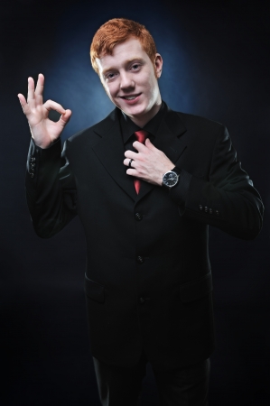 A red-haired businessman showing gestureの写真素材