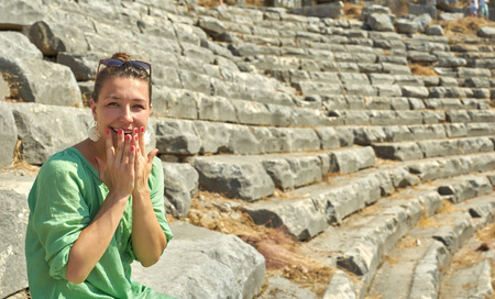 surprised woman on the ruins of the Colosseum. Turkey, Kemer.の写真素材
