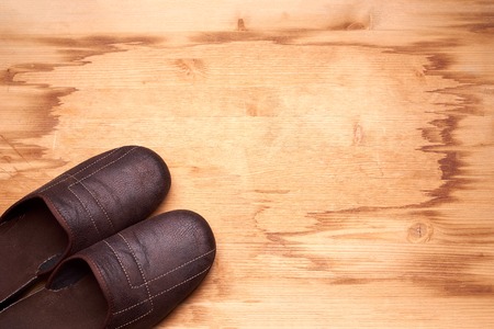 Men's slippers on the wooden floorの写真素材