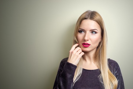 Fashion model with bright make-up. Portrait of young fashion woman with long blond hairの写真素材