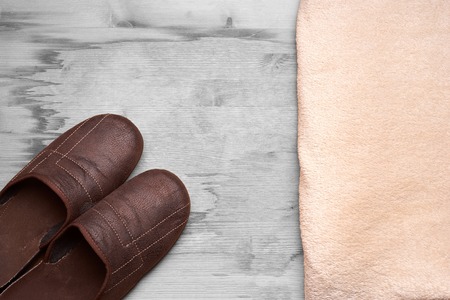 Men's slippers on the wooden tableの写真素材