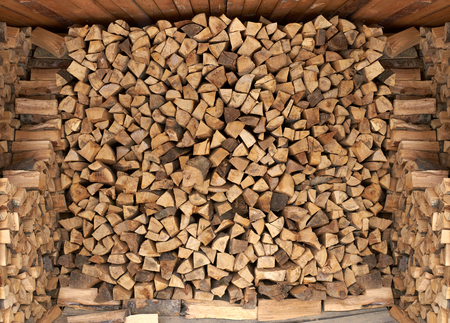 Dry firewood in a pile for furnace kindling