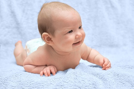 Happy baby lying on bed