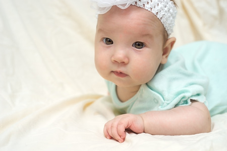Happy baby lying on bed