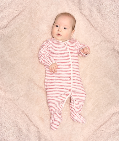 Happy baby lying on bed