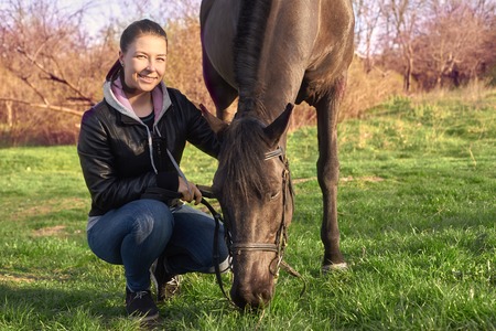 Portrait of a dark horse and womanの写真素材