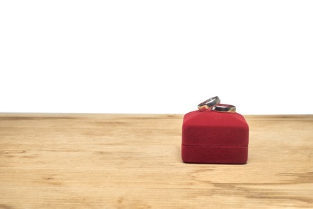 wedding rings and jewelry box on a wooden table