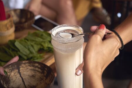 woman tastes tasty and healthy almond milk. vegetarianism.