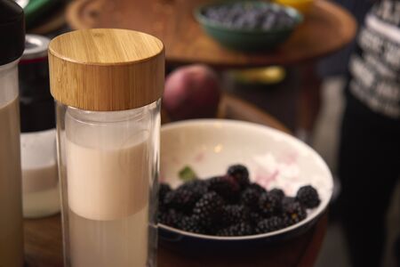 A container for coconut milk is on the table. Tasty and healthyの写真素材