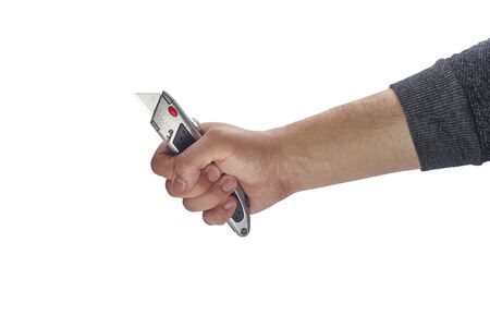 Man holds a stationery knife on a white isolatedの写真素材