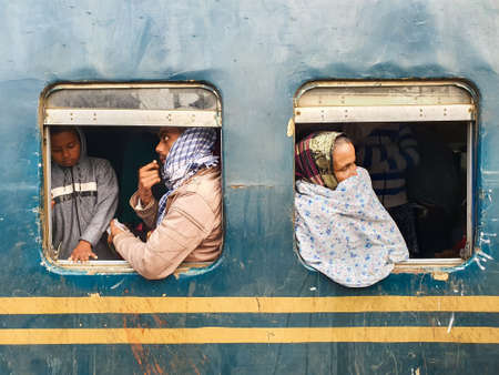 Dhaka,Bangladesh-01/11/2020:Bangladesh railway-Man and old woman looking through the window from a crowded trainのeditorial素材