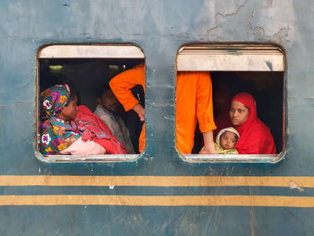 Dhaka,Bangladesh-01/11/2020:Bangladesh railway-Woman with children looking through the window from a crowded trainのeditorial素材