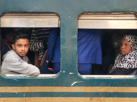 Dhaka,Bangladesh-01/11/2020:Bangladesh railway-young boy and old woman looking through the window from a crowded trainのeditorial素材