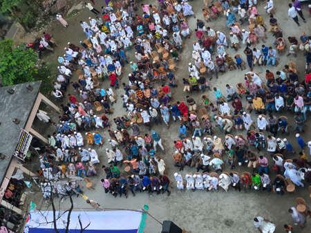 Top View of Group of Islamic people gathered in a cultural meeting during the corona with some people having masks in a village in Bangladeshのeditorial素材