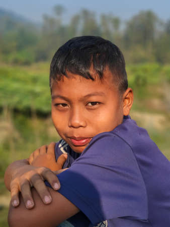 Bandarban, Bangladesh - 06.03.202: young boy from a different ethnicity smiling at the camera from the hilly area of Bangladesh. Aboriginal young boy from Bandarbanのeditorial素材