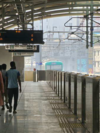 Mirpur, Dhaka, Bangladesh - 03.13.2023: People at the Dhaka Mirpur 10 Metro Rail Station, waiting for the metro train to arrive at the platform in the morning.のeditorial素材