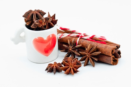 cinnamon bark in the lovely heart cup on a white backgroundの写真素材