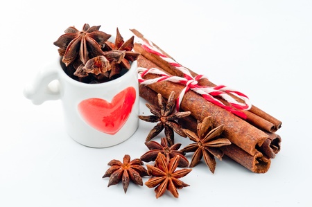 cinnamon bark in the lovely heart cup on a white backgroundの写真素材