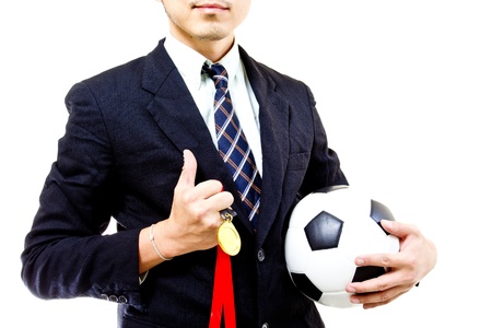 Football manager hold ball with his hands in studioの写真素材
