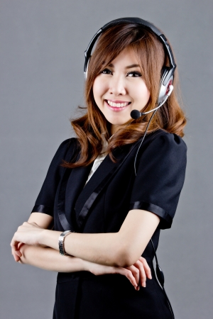 Asian women call center with phone headset with white backgroundの写真素材
