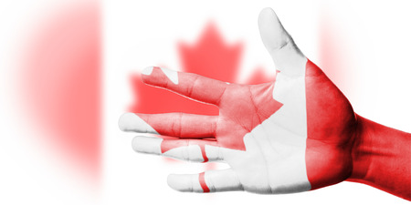 Cheering fan with Painting national Canada flag with your hand with your hand for cheer your national sportの写真素材