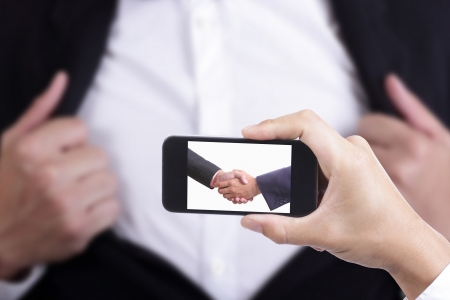 Businessman capture for check co ordinate by sharke hand の写真素材