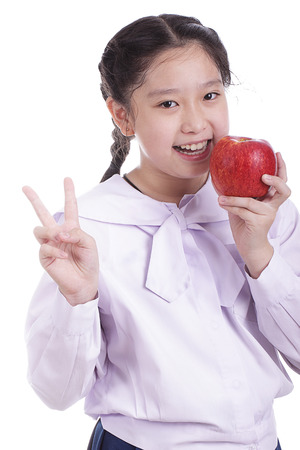 Student girl hold red apple with white backgroundの写真素材