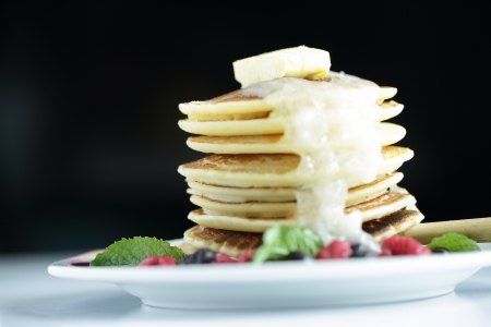 Mixed berry pancakes on the white dishの写真素材