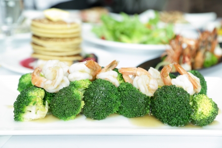 Gravy and Shrimp with broccoli on white dishの写真素材