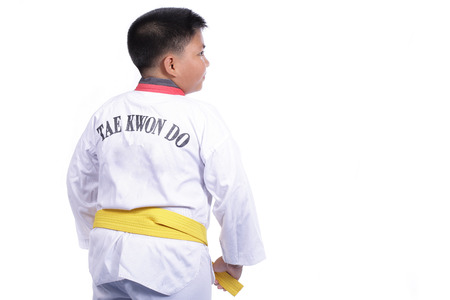 Handsome taekwondo boy trained fight activity with white backgroundの写真素材
