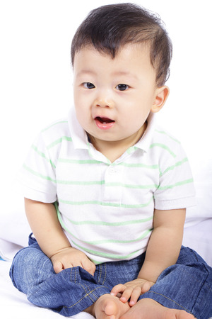 little boy smile and do activity something in studioの写真素材