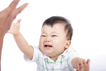 little boy smile and do activity something in studioの写真素材