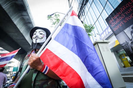 BANGKOK - DEC 9: Many Masked protesters walked for anti government corruption on December 09, 2013 in Bangkok, Thailand. The protesters required Yingluck Shinawatra Prime Minister resign.のeditorial素材