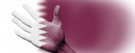 Cheering fan with Painting national Qatar flag with your hand with your hand for cheer your national sportの写真素材