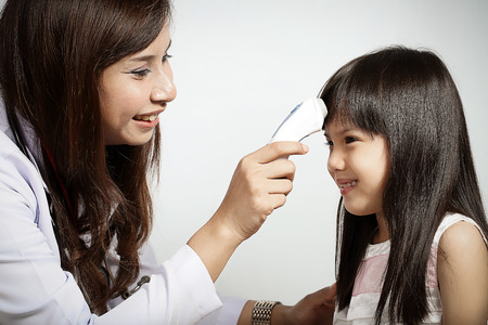 Doctor checked children girl's temperature in Clinic 
