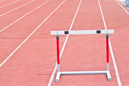 hurdles on the red running track prepared for competition.の写真素材