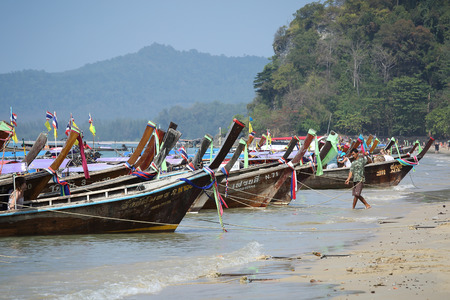 KRABI,THAILAND - CIRCA JANUARY 2013 - Traveler came to travel in high season by Thai Long tailed boat at Ao Nang circa January in Krabi, The center boat  transportation by sea in 2013 のeditorial素材