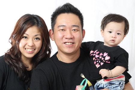 Asian Family portrait inside home with white background. の写真素材