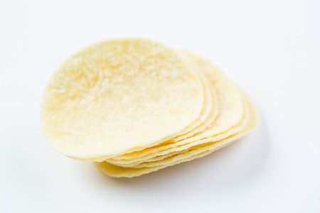 Macro Potato chips stack on the white backgroundの写真素材