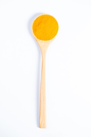 chilli powder on wood spoon with white backgroundの写真素材