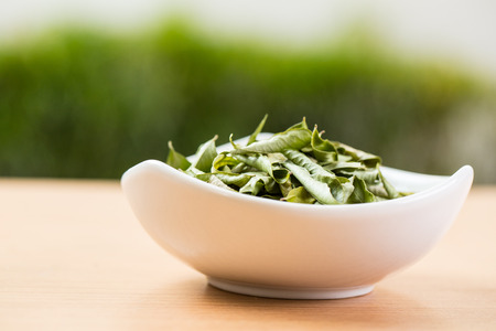Close up Dried curry leaves with white background