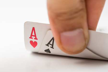 Player opened  aces pocker cards isolated with white backgroundの写真素材