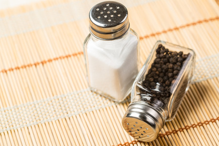 Two pepper bottles on Japanese linen woodの写真素材