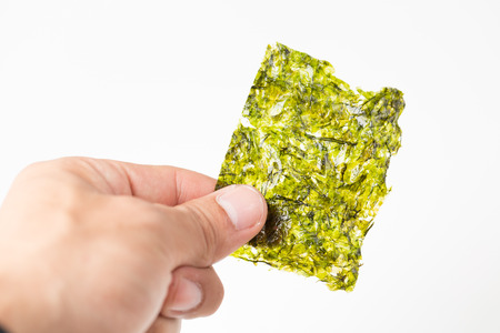 Laver seaweed sheet roasted isolated with white backgroundの写真素材
