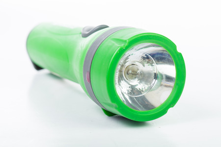 Green flashlight isolated with white backgroundの写真素材
