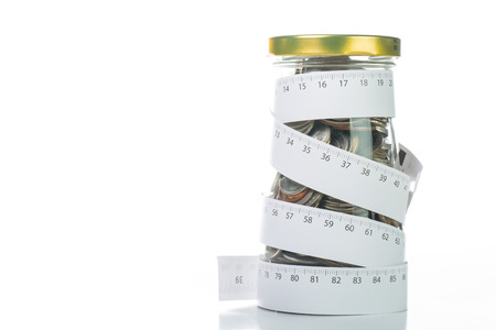 Rolling deposit money by Measuring tape for tie your budget.の写真素材