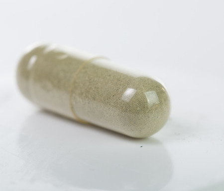 Pills and drug container isolated with white backgroundの写真素材